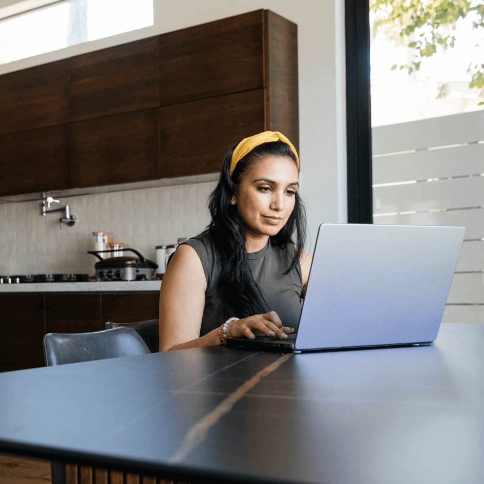 Aya Education woman working on laptop